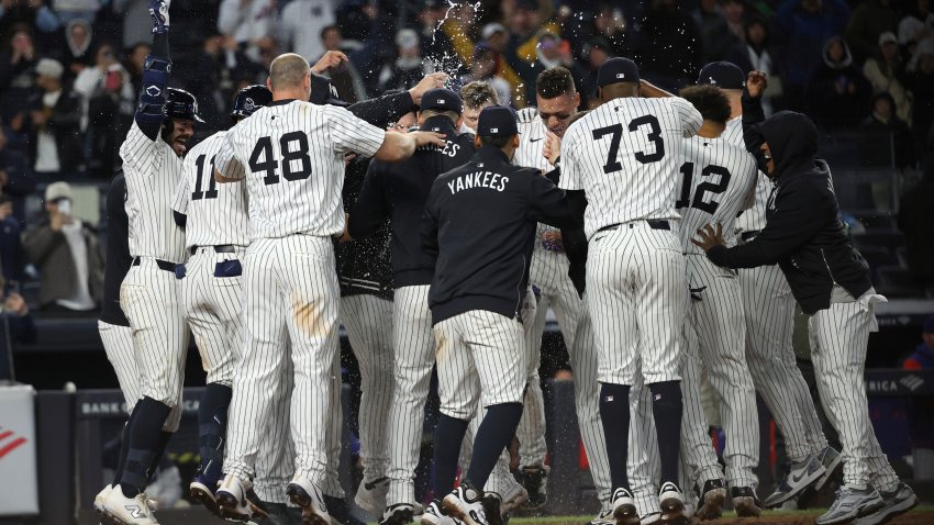 New York Yankees players react after winning a baseball game against the Texas Rangers on a walk off home run hit by Jasson Domínguez, Wednesday, May 21, 2025, in New York. (AP Photo/Pamela Smith)