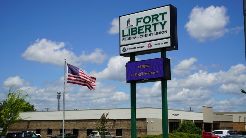 An American flag flaps in the breeze outside the Fort Liberty Federal Credit Union