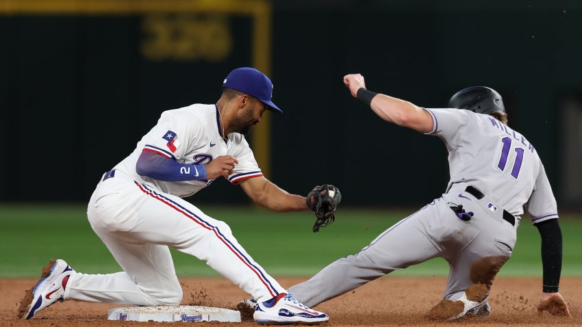 ARLINGTON, TEXAS – MAY 14: Owen Miller #11 of the Colorado Rockies steals second base ahead of the tag of Marcus Semien #2 of the Texas Rangers during the third inning at Globe Life Field on May 14, 2025 in Arlington, Texas.