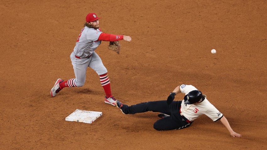 ARLINGTON, TEXAS – MAY 30: Brendan Donovan #33 of the St. Louis Cardinals throws to first base over Corey Seager #5 of the Texas Rangers during the fifth inning at Globe Life Field on May 30, 2025 in Arlington, Texas.