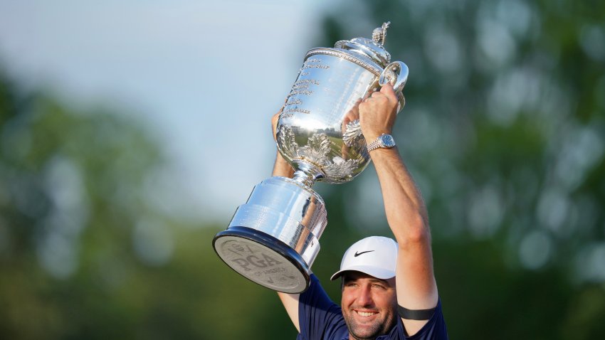 May 18, 2025; Charlotte, North Carolina, USA; Scottie Scheffler holds up the Wanamaker Trophy after winning the PGA Championship golf tournament at Quail Hollow. Mandatory Credit: Aaron Doster-Imagn Images
