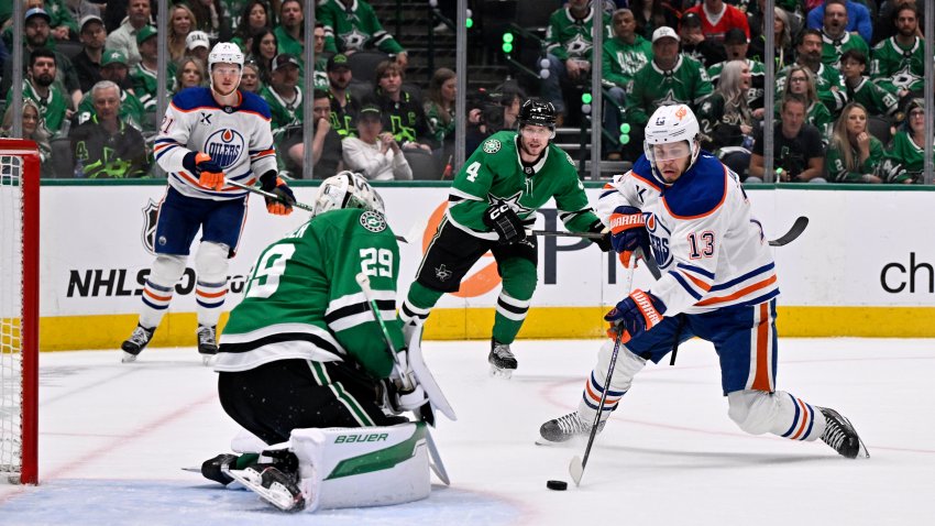May 23, 2025; Dallas, Texas, USA; Edmonton Oilers center Mattias Janmark (13) shoots the puck on Dallas Stars goaltender Jake Oettinger (29) in the third period for game two of the Western Conference Final of the 2025 Stanley Cup Playoffs at American Airlines Center. Mandatory Credit: Jerome Miron-Imagn Images