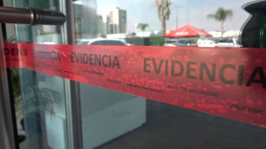 Crime scene tape is pictured on a door to a beauty salon in Zapopan, Mexico.