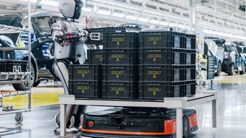 A humanoid robot from UBTech moves a load onto an automated guided vehicle (AGV) in an electric car factory for Geely-backed Zeekr on Aug. 5, 2024, in Ningbo, Zhejiang province of China.