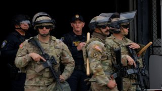 Members of the California National Guard stand outside the Edward R. Roybal federal building after their deployment by U.S. President Donald Trump, in response to protests against immigration sweeps, in Los Angeles on June 8, 2025.