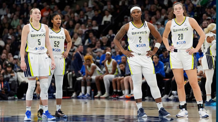 Dallas Wings guard Paige Bueckers (5), guard Tyasha Harris (52), forward Myisha Hines-Allen (2) and forward Maddy Siegrist (20) stand on court during the second half of a WNBA basketball game against the Minnesota Lynx, Wednesday, May 21, 2025, in Minneapolis.