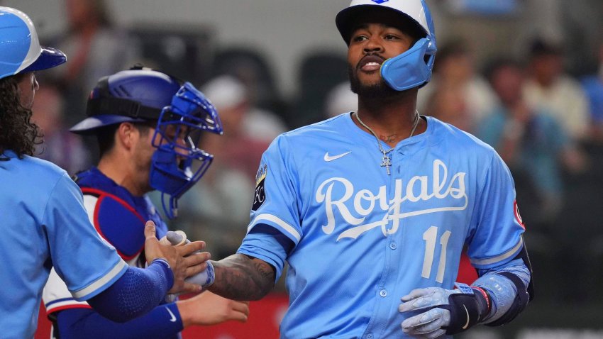 Kansas City Royals’ Maikel Garcia celebrates his home run that scored teammates Jonathan India and Bobby Witt Jr. during the fourth inning of a baseball game against the Texas Rangers, Wednesday, June 18, 2025, in Arlington, Texas.