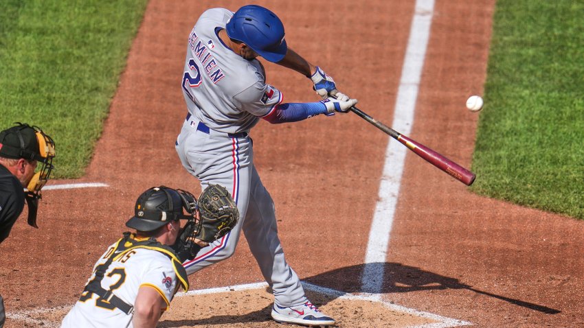 Texas Rangers’ Marcus Semien (2) drives in a run with a sacrifice fly off Pittsburgh Pirates pitcher Mitch Keller during the sixth inning of a baseball game in Pittsburgh, Saturday, June 21, 2025. (AP Photo/Gene J. Puskar)