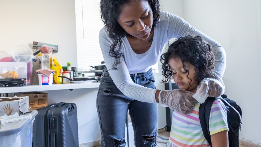 As part of her daily routine, Deysi Vargas runs a saline solution through her daughter’s intravenous line before her morning shower and school.