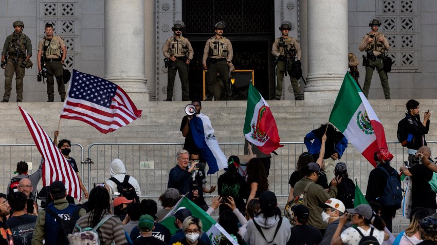 Sheriff deputies stand guard as demonstrators gather on the steps of City Hall
