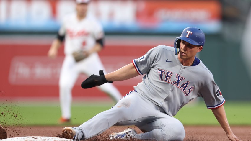BALTIMORE, MD – JUNE 25:   Corey Seager #5 of the Texas Rangers slides into third base in the fifth inning during the game between the Texas Rangers and the Baltimore Orioles at Oriole Park at Camden Yards on Wednesday, June 25, 2025 in Baltimore, Maryland.