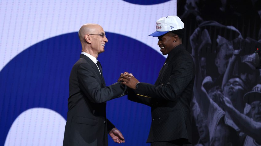 NEW YORK, NEW YORK – JUNE 25: VJ Edgecombe (R) shakes hands with NBA commissioner Adam Silver (L) after being drafted second overall by the Philadelphia 76ers during the first round of the 2025 NBA Draft at Barclays Center on June 25, 2025 in the Brooklyn borough of New York City.
