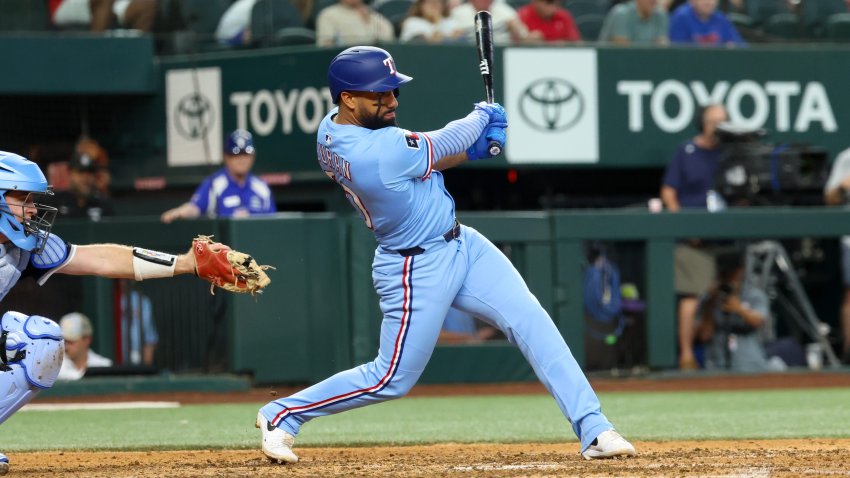 Jun 15, 2025; Arlington, Texas, USA;  Texas Rangers third baseman Ezequiel Duran (20) doubles during the eighth inning against the Chicago White Sox at Globe Life Field. Mandatory Credit: Kevin Jairaj-Imagn Images