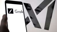 The Grok logo is being displayed on a smartphone with Xai visible in the background in this photo illustration on April 1, 2024. 