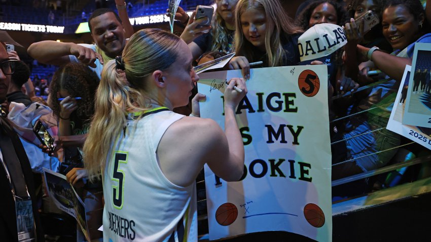 ARLINGTON, TX –  SEPTEMBER 11: Paige Bueckers #5 of the Dallas Wings sign and autograph after the game against the Phoenix Mercury on September 11, 2025 at the College Park Center in Arlington, TX.