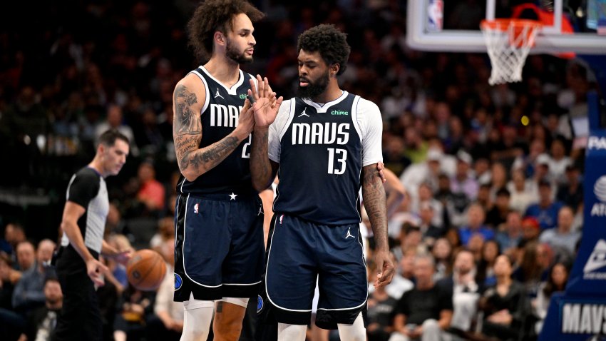 Nov 21, 2025; Dallas, Texas, USA; Dallas Mavericks forward Naji Marshall (13) is retrained by center Dereck Lively II (2) after Marshall receives a technical foul during the second half against the New Orleans Pelicans at the American Airlines Center. Mandatory Credit: Jerome Miron-Imagn Images