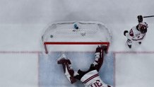 Sweden's #09 Filip Forsberg (top) celebrates after scoring their 3-0 goal during the men's qualification play-off hockey match between Sweden and Latvia.