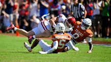 Oct 11, 2025; Dallas, Texas, USA; Oklahoma Sooners tight end Jaren Kanak (12) is tackled by Texas Longhorns defensive back Malik Muhammad (5) and linebacker Anthony Hill Jr. (0) during the first half at the Cotton Bowl. Mandatory Credit: Jerome Miron-Imagn Images