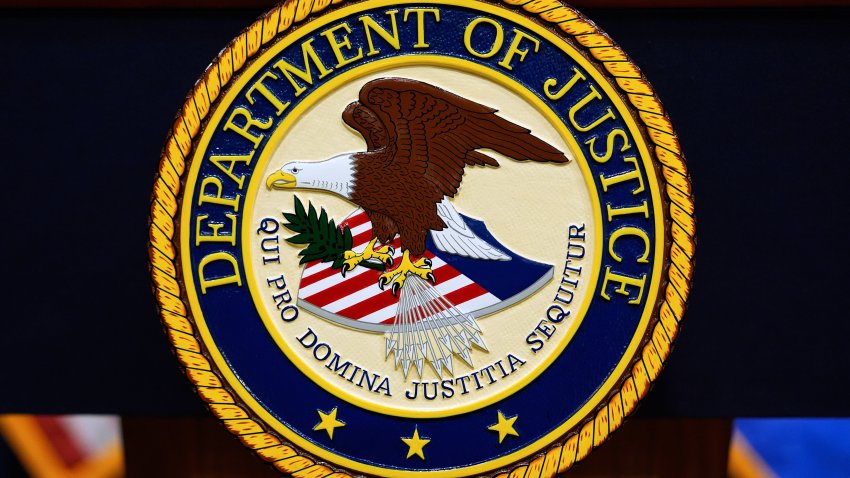 FILE - The U.S. Department of Justice logo is seen on a podium before a news conference at the Justice Department in Washington, on May 6, 2025.