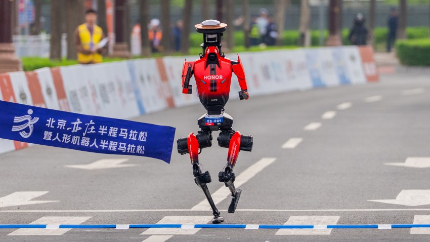 BEIJING, CHINA – APRIL 19: Honor’s “Lightning” humanoid robot from team Qitian Dasheng (Great Sage) crosses the finish line during the Beijing humanoid robot half marathon, on April 19, 2026 in Beijing, China. Completing the race with a net time of 50 minutes and 26 seconds, the champion robot showcased an impressive performance, beating the human half marathon record of 57 minutes and 20 seconds.