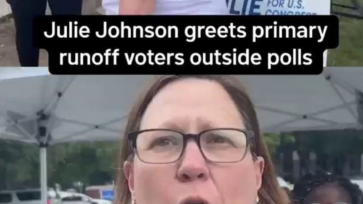 Julie Johnson greets primary runoff voters outside the polls