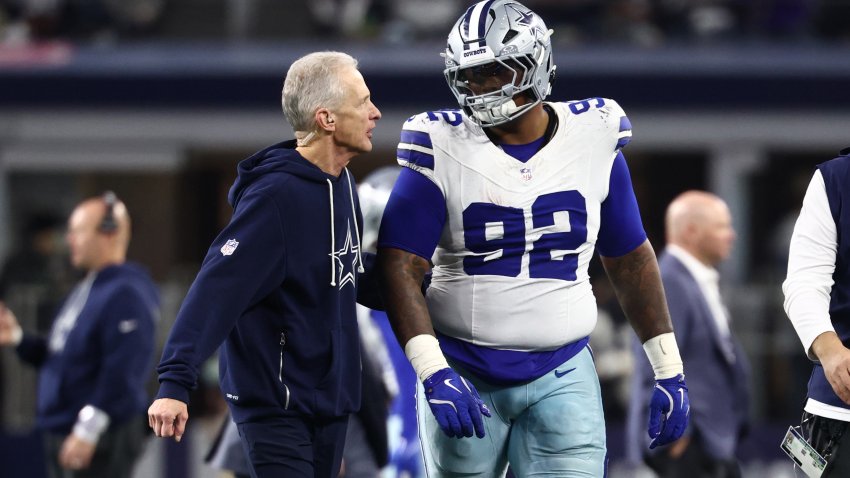 Dec 14, 2025; Arlington, Texas, USA; Dallas Cowboys defensive tackle Quinnen Williams (92) walks off the field with trainers after an injury during the second half against the Minnesota Vikings at AT&T Stadium.