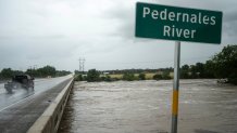 The Pedernales River floods underneath State Highway 87 on Thursday, July 16, 2026, in Fredericksburg, Texas.