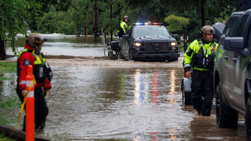 UVALDE, TEXAS – JULY 16: First responders with the Texas Game Wardens travel up East Mesquite Street in Uvalde on Thursday, July 16, 2026, after performing a water rescue, after the Leona River flooded the roadway. (Sam Owens/San Antonio Ex