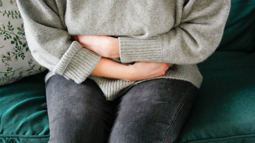 Woman suffers from stomachache.