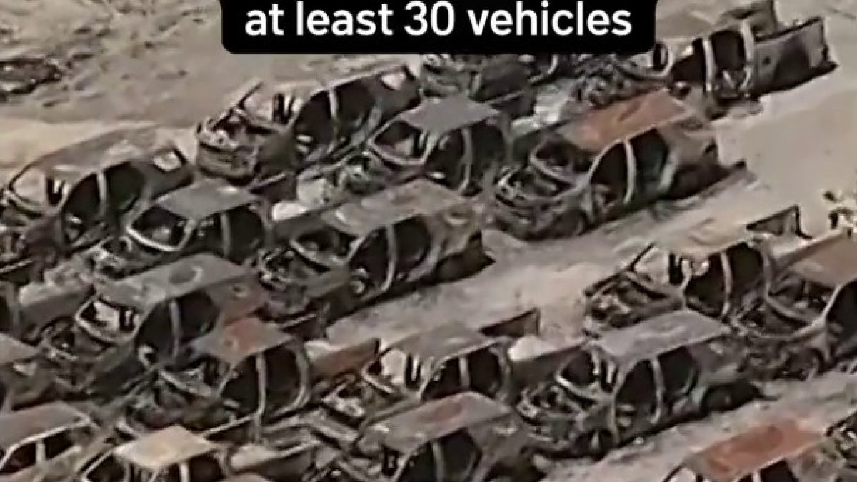 Aerial views show parking lot where fire charred at least 30 vehicles