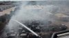 About 30 vehicles left charred after crews battle Grand Prairie parking lot fire