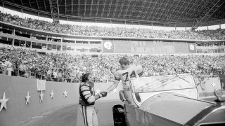 FILE – Philadelphia Eagles guard John Niland (74), right, shakes hands with retired Dallas Cowboys tackle Bob Lilly (74) during half-time ceremonies honoring Lilly at Texas Stadium in Irving, Nov. 23, 1975. Niland and Lilly were teammates the previous year.