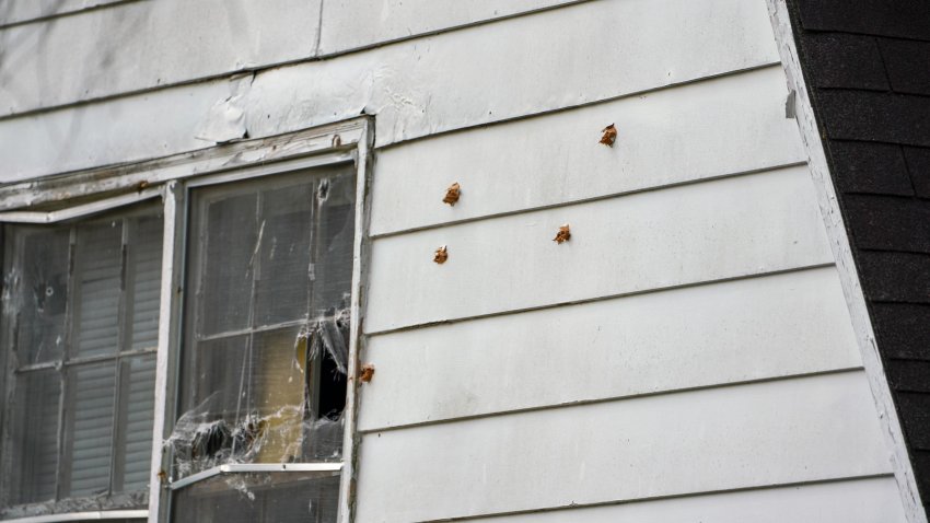 Bullet holes on a house at the scene of the April 29, 2024, shooting in Charlotte, N.C., where four law enforcement officers, including three on a U.S. Marshals Task Force, were killed and four other officers were injured Monday after being shot while attempting to serve a warrant.