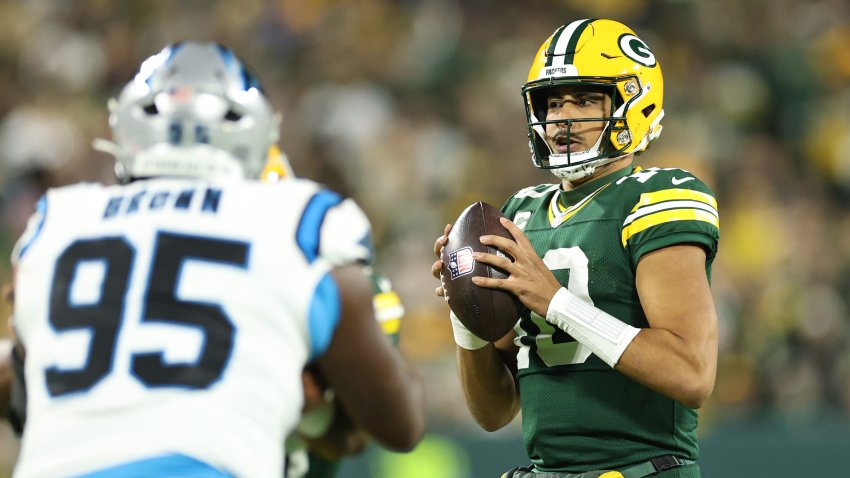 Jordan Love #10 of the Green Bay Packers steps back to pass against the Carolina Panthers.