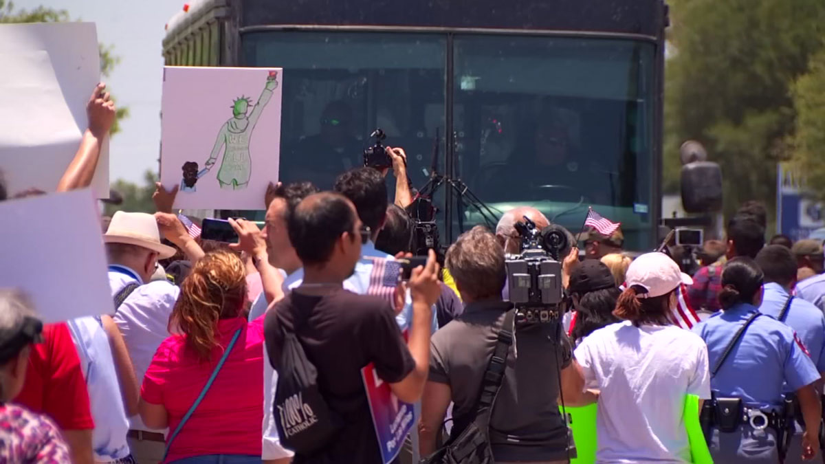 Rally Heats Up When Bus Carrying Migrant Families Drives By
