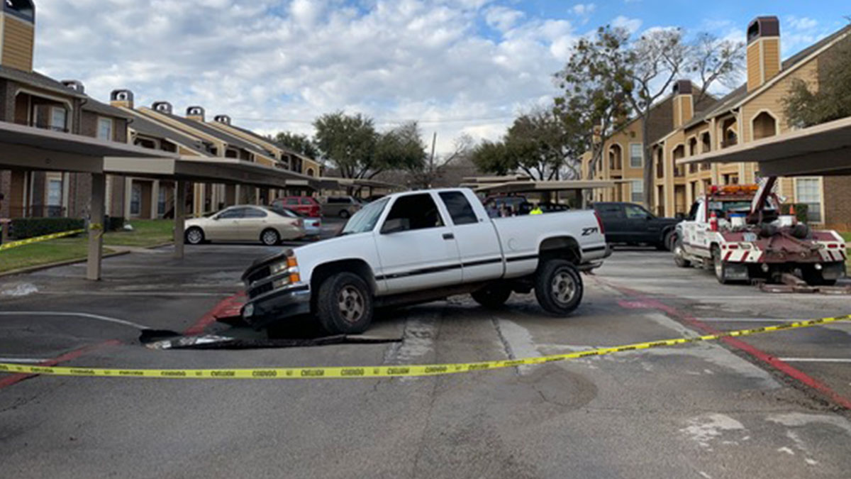 Sinkhole Opens at Apartment Complex, Swallows Part of Truck